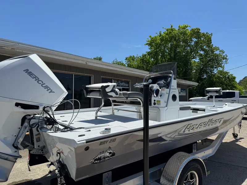 Slide: The Image of 2023 Polar Kraft BAY210CC boat with Mercury engine, docked outdoors. - 3