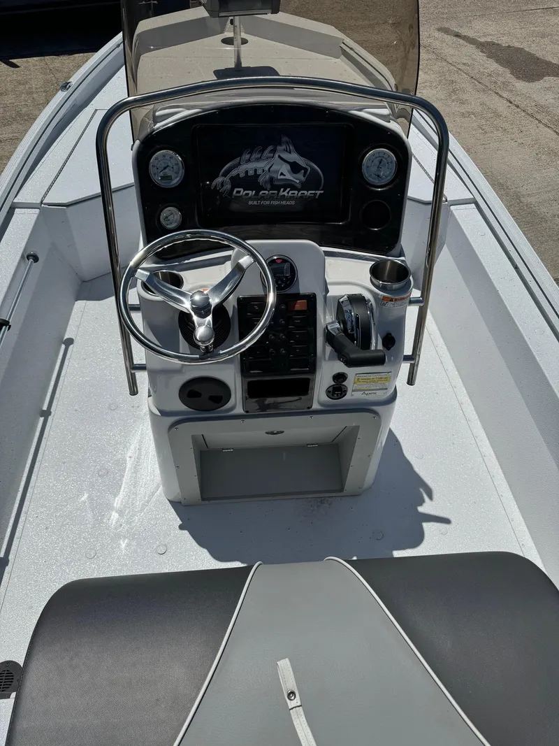 Slide: The Image of 2023 Polar Kraft BAY210CC boat console with steering wheel and controls. - 6