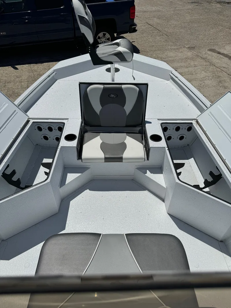 Slide: The Image of 2023 Polar Kraft BAY210CC boat interior with open storage compartments and seating. - 9