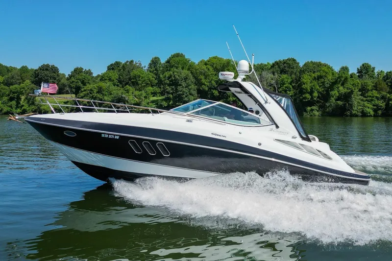 The Image of 2008 Cruisers Yachts 330 Express cruising on a lake with lush green trees. - 0