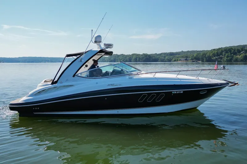 Slide: The Image of 2008 Cruisers Yachts 330 Express on calm lake with scenic background. - 11