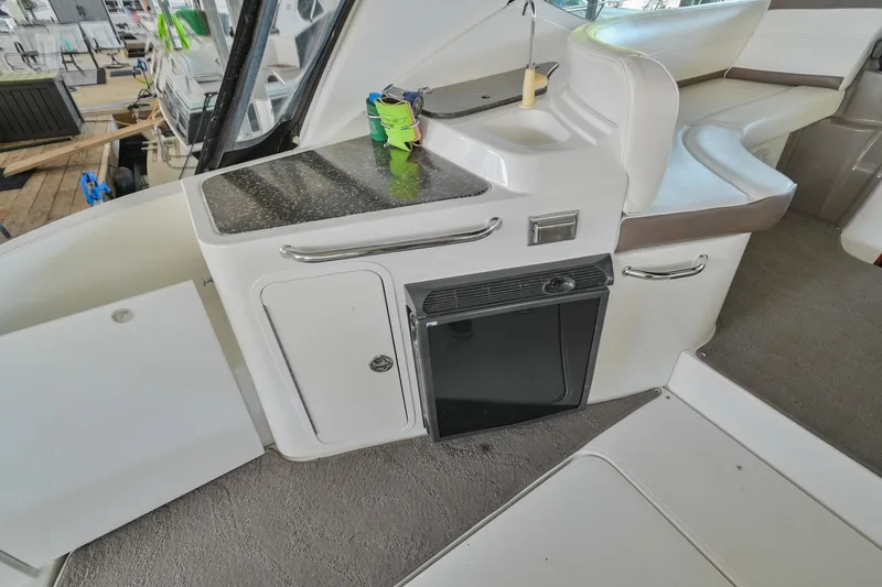 Slide: The Image of 2008 Cruisers Yachts 330 Express interior galley with sink and mini-fridge. - 25