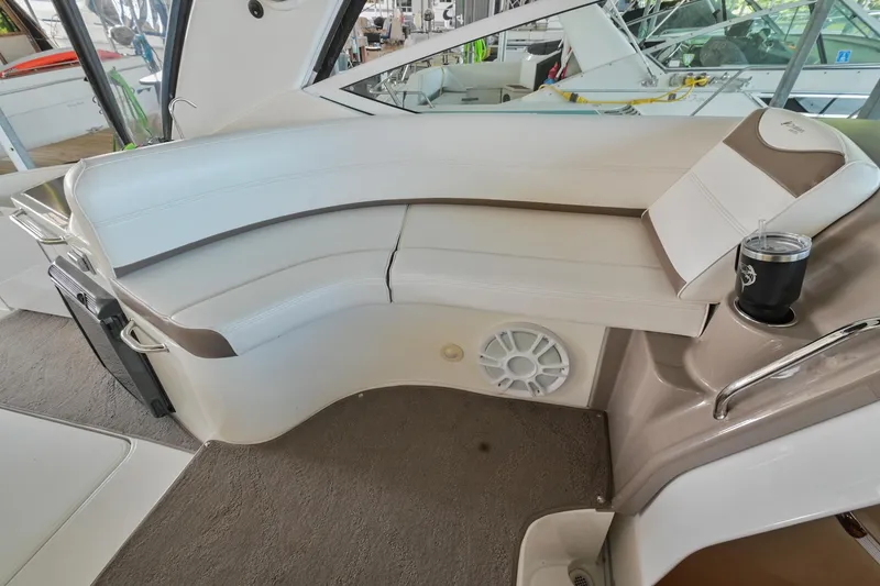 Slide: The Image of 2008 Cruisers Yachts 330 Express interior seating area with cup holder and speaker. - 28