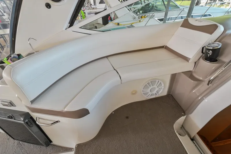 Slide: The Image of 2008 Cruisers Yachts 330 Express interior seating area with white and brown upholstery. - 29