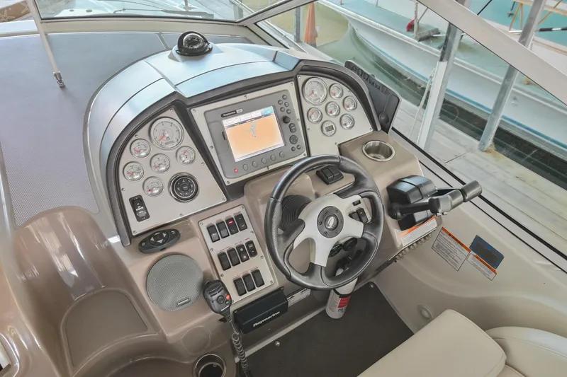 Slide: The Image of 2008 Cruisers Yachts 330 Express helm with navigation system and controls. - 32
