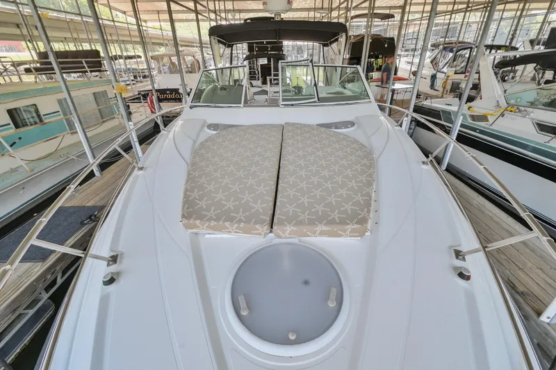 Slide: The Image of 2008 Cruisers Yachts 330 Express boat deck with sun pads in marina. - 38