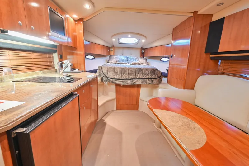 Slide: The Image of 2008 Cruisers Yachts 330 Express interior with kitchen, seating, and bed. - 44