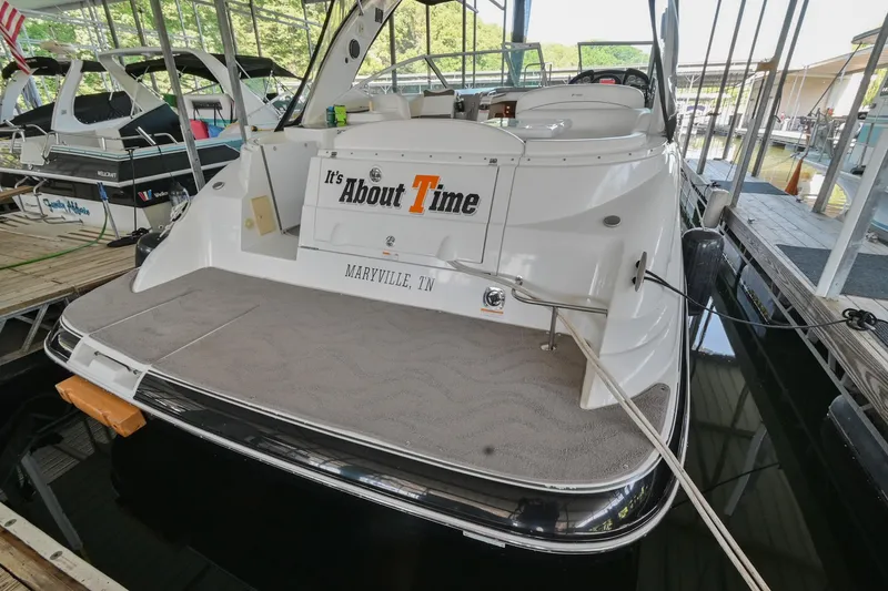 Slide: The Image of 2008 Cruisers Yachts 330 Express docked, rear view with It's About Time sign. - 17