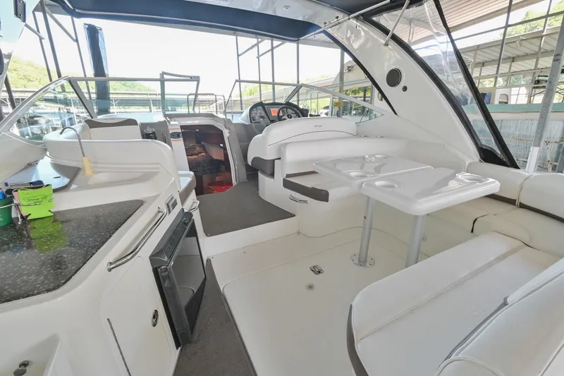 Slide: The Image of 2008 Cruisers Yachts 330 Express interior with seating, table, and kitchenette. - 19