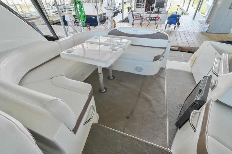 Slide: The Image of 2008 Cruisers Yachts 330 Express interior with white seating and dining table. - 20