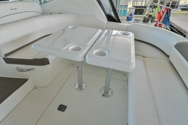 Slide: The Image of 2008 Cruisers Yachts 330 Express interior seating area with dual tables. - 22