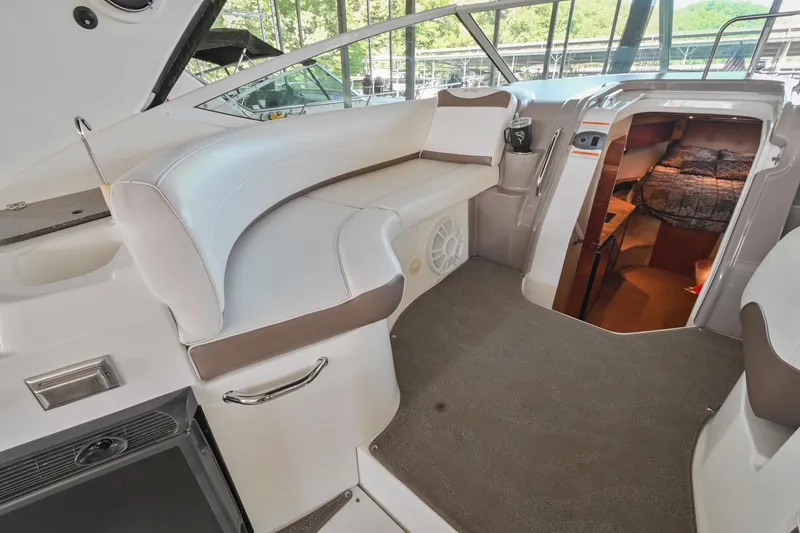 Slide: The Image of 2008 Cruisers Yachts 330 Express interior with white seating and cabin entrance. - 27