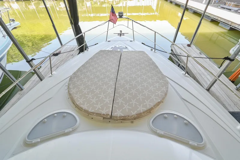 Slide: The Image of 2008 Cruisers Yachts 330 Express bow with sunpad and American flag. - 36
