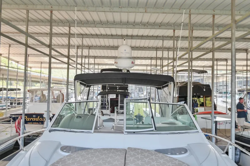 Slide: The Image of 2008 Cruisers Yachts 330 Express docked in a covered marina. - 39