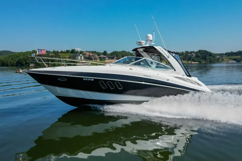 Slide: The Image of 2008 Cruisers Yachts 330 Express speeding on a lake with scenic background. - 6