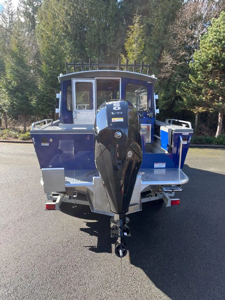 Slide: The Image of 2024 Spartan 220 Maximus boat with outboard motor, rear view. - 3