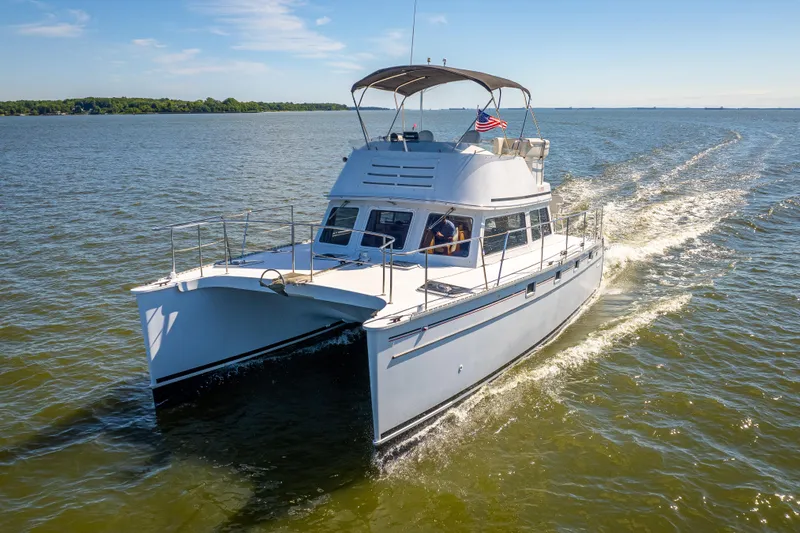 Slide: The Image of 2002 PDQ Power Catamaran MV/34 Passagemaker cruising on open water. - 10