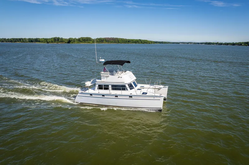 Slide: The Image of 2002 PDQ Power Catamaran MV/34 Passagemaker cruising on a calm lake. - 11
