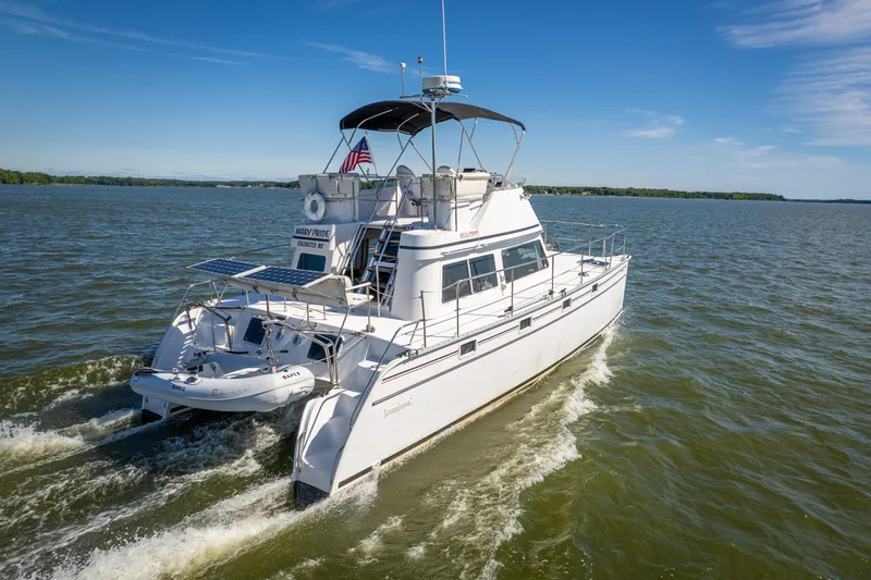 Slide: The Image of 2002 PDQ Power Catamaran MV/34 Passagemaker cruising on open water. - 12