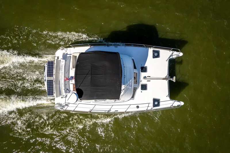 Slide: The Image of Aerial view of 2002 PDQ Power Catamaran MV/34 Passagemaker cruising on water. - 13