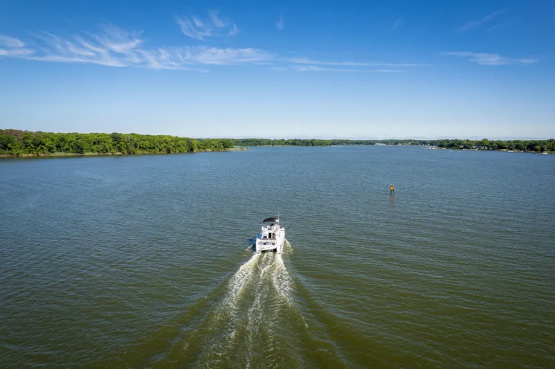 Slide: The Image of PDQ Power Catamaran MV/34 Passagemaker cruising on a serene lake, 2002 model. - 14