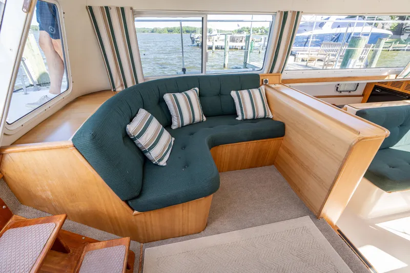 Slide: The Image of Interior of 2002 PDQ Power Catamaran MV/34 Passagemaker with green seating and striped pillows. - 19