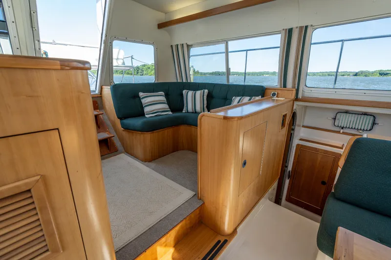 Slide: The Image of Interior of 2002 PDQ Power Catamaran MV/34 Passagemaker with green seating and striped pillows. - 24