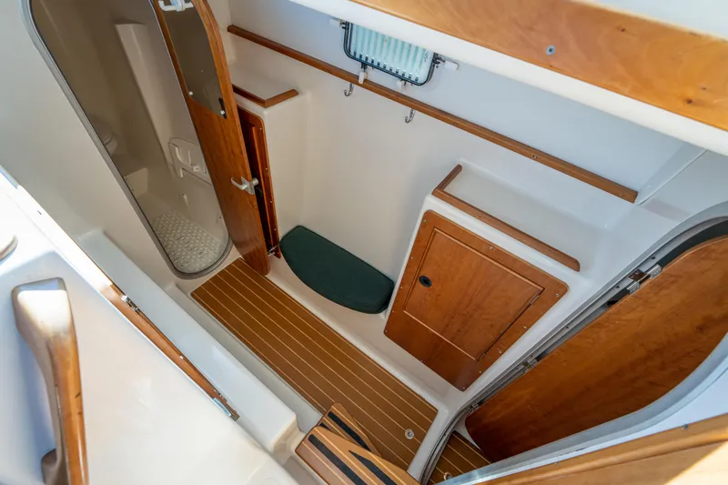 Slide: The Image of Interior of 2002 PDQ Power Catamaran MV/34 Passagemaker, featuring wooden cabinetry and compact shower. - 26