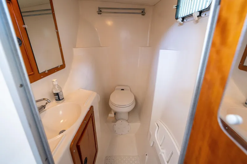 Slide: The Image of Bathroom of 2002 PDQ Power Catamaran MV/34 Passagemaker with sink, toilet, and mirror. - 28