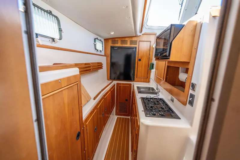 Slide: The Image of Interior galley of 2002 PDQ Power Catamaran MV/34 Passagemaker with wood cabinetry and appliances. - 33