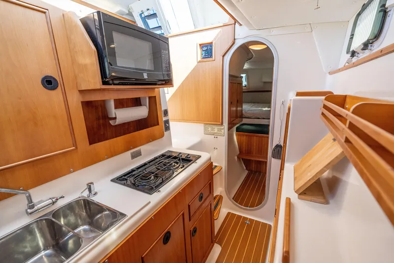 Slide: The Image of 2002 PDQ Power Catamaran MV/34 Passagemaker galley with stove, microwave, and sink. - 35