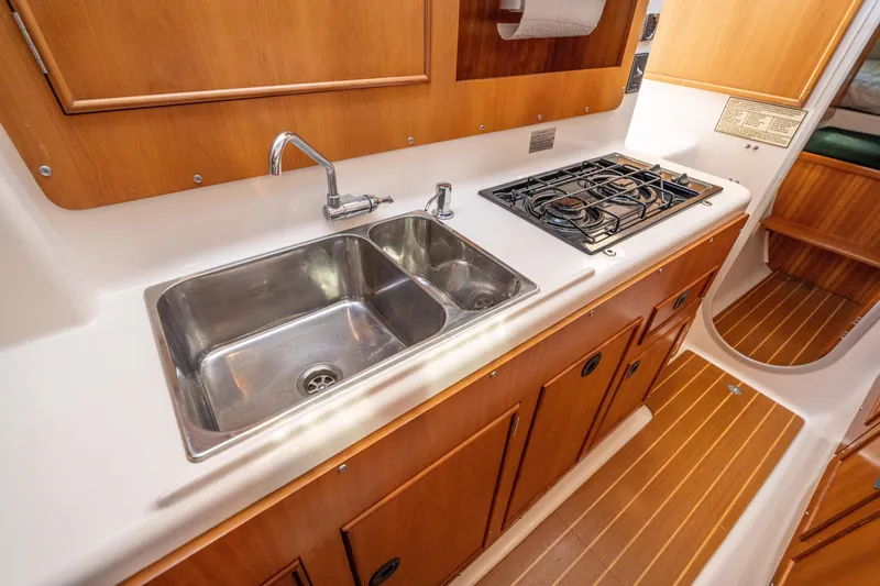 Slide: The Image of 2002 PDQ Power Catamaran MV/34 Passagemaker kitchen with double sink and gas stove. - 36