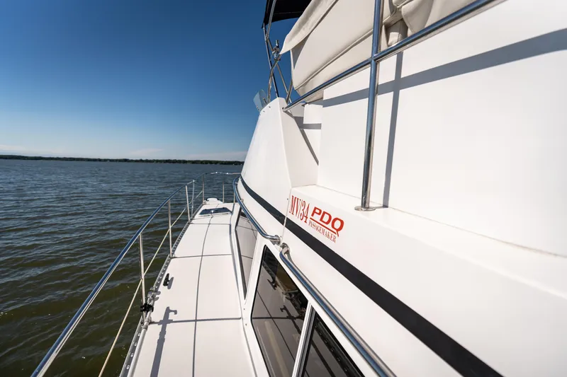 Slide: The Image of 2002 PDQ Power Catamaran MV/34 Passagemaker on calm waters under clear blue sky. - 40