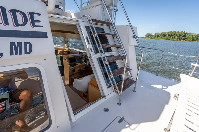 Slide: The Image of 2002 PDQ Power Catamaran MV/34 Passagemaker, cockpit view with helm and stairs to upper deck. - 42