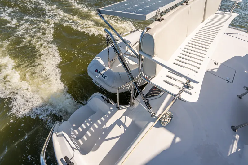 Slide: The Image of 2002 PDQ Power Catamaran MV/34 Passagemaker with Apex dinghy on water. - 43