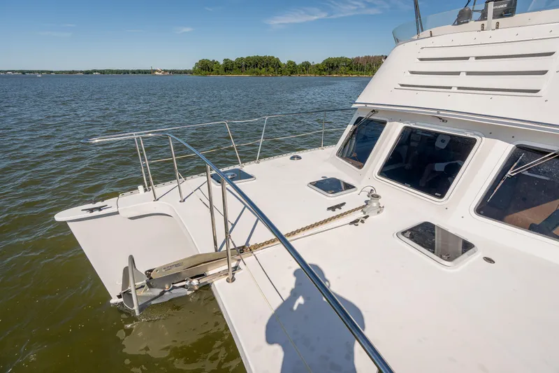 Slide: The Image of 2002 PDQ Power Catamaran MV/34 Passagemaker on calm waters with scenic background. - 46
