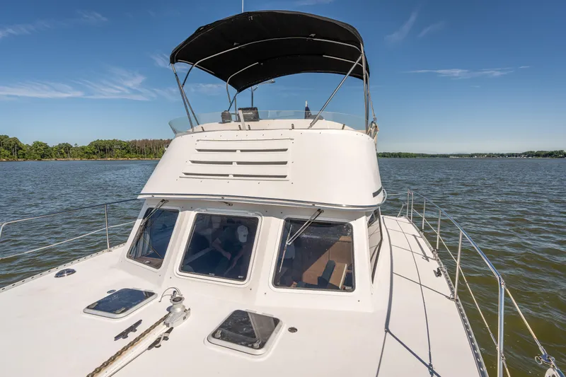 Slide: The Image of 2002 PDQ Power Catamaran MV/34 Passagemaker on calm waters with clear sky. - 47