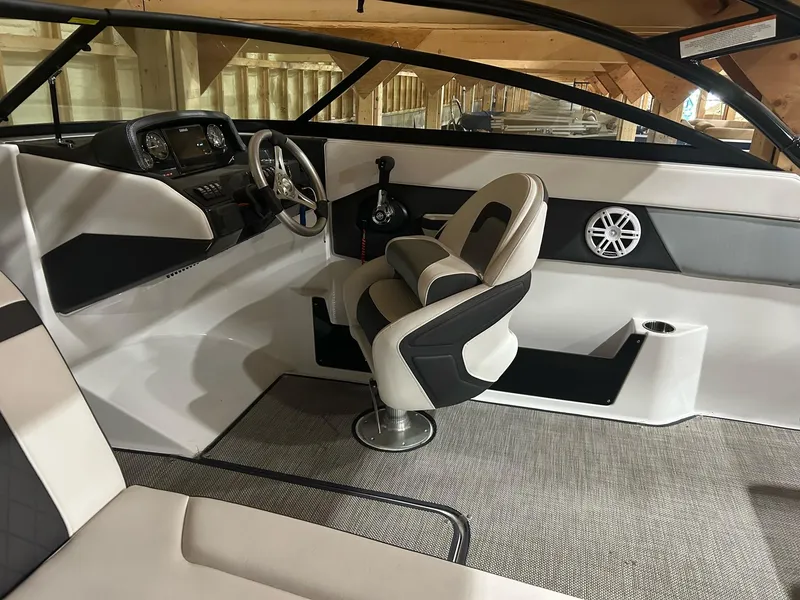 Slide: The Image of 2022 Monterey M-225 boat interior with modern helm and comfortable seating. - 2