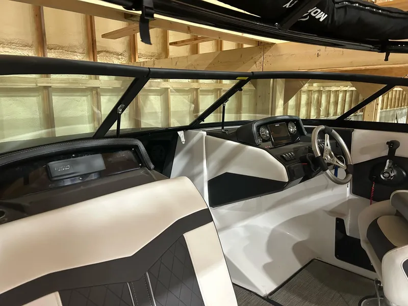 Slide: The Image of Interior of a 2022 Monterey M-225 boat with modern dashboard and seating. - 4