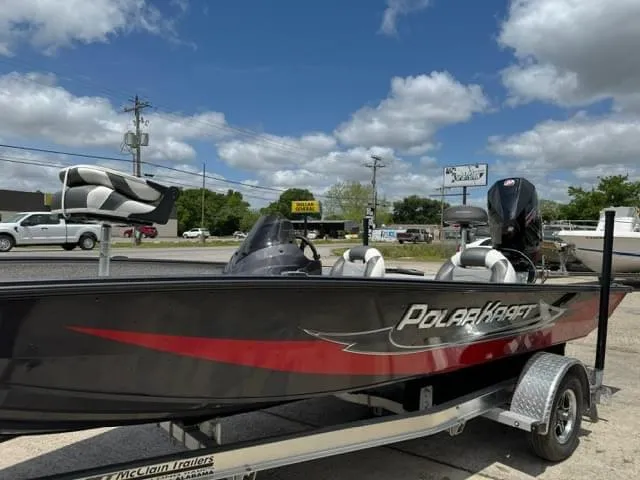 Slide: The Image of 2023 Polar Kraft 195 Pro boat on a trailer, parked outdoors under a blue sky. - 8