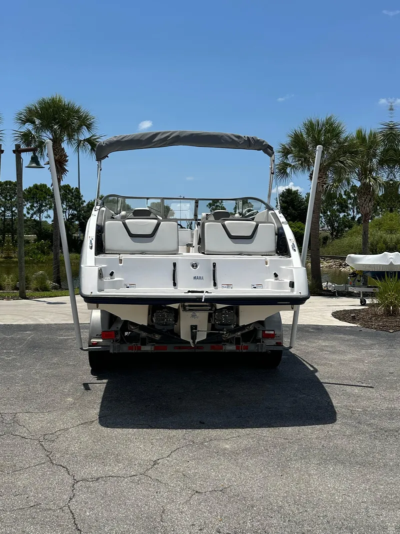Slide: The Image of 2022 Yamaha Boats SX250, rear view, parked on a sunny day. - 18
