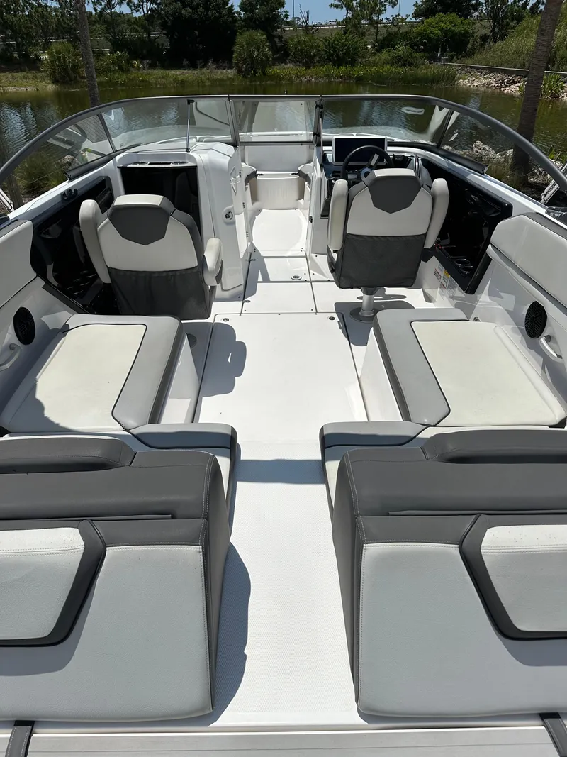 Slide: The Image of 2022 Yamaha Boats SX250 interior with seating and steering console. - 19