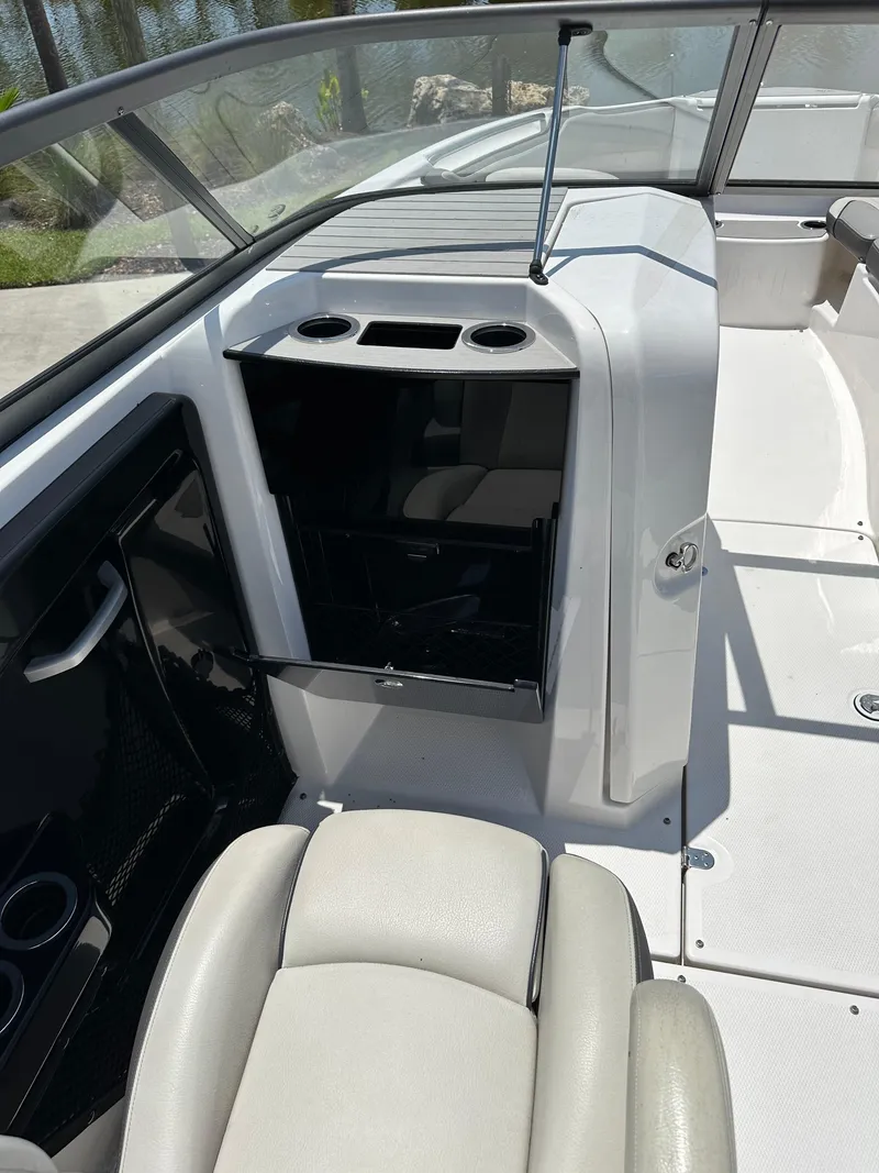 Slide: The Image of 2022 Yamaha Boats SX250 interior cockpit with seating and storage compartments. - 23