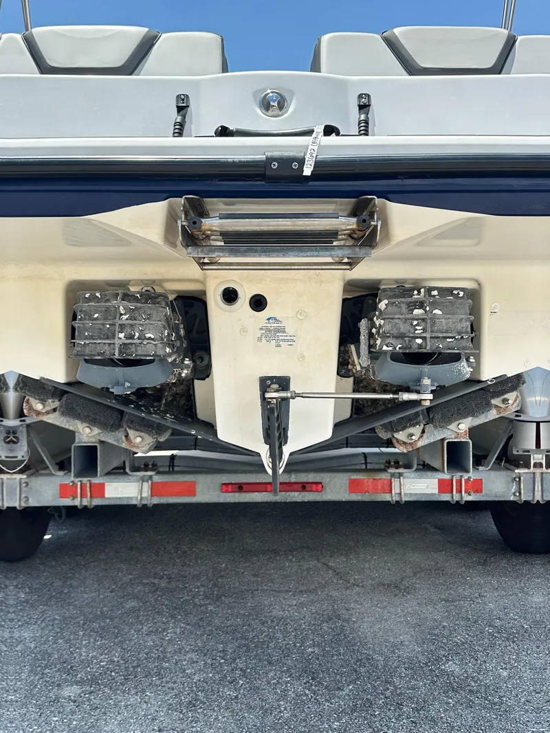 Slide: The Image of 2022 Yamaha Boats SX250 rear view on trailer, showcasing dual engines and hull design. - 5
