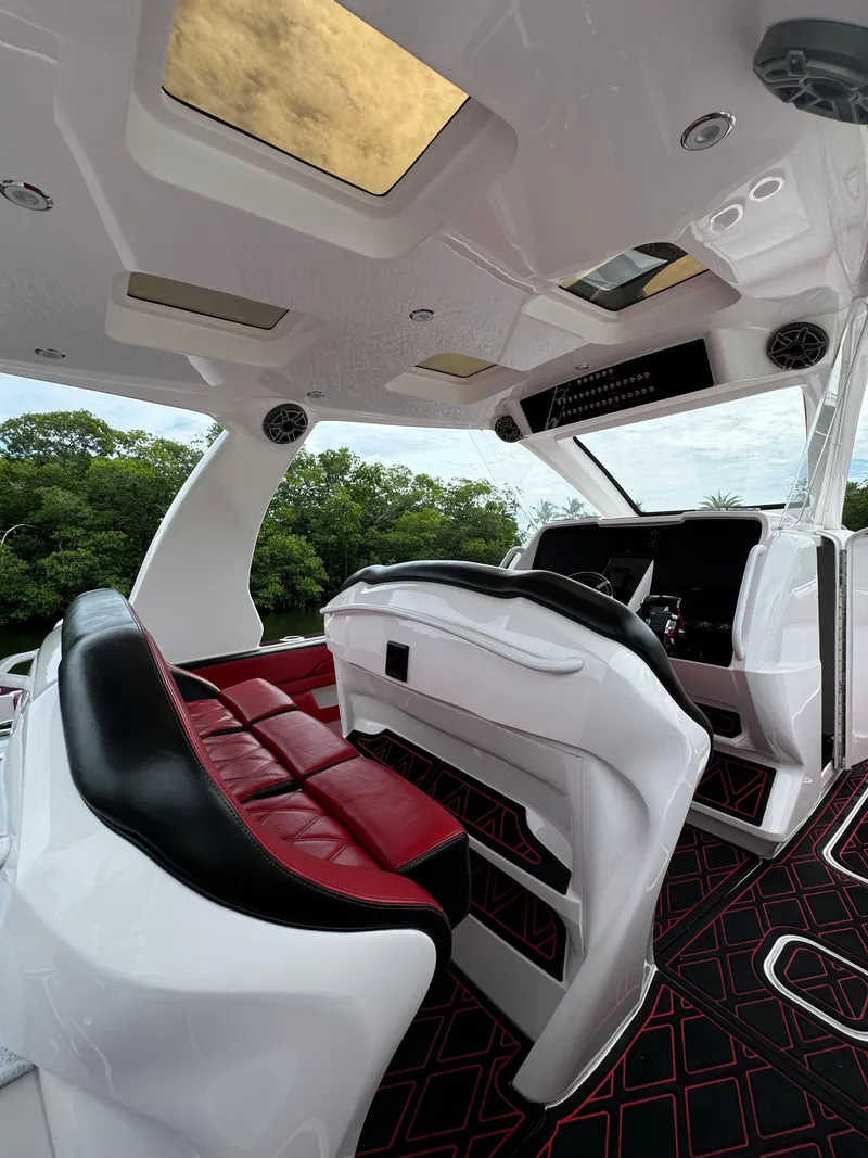 Slide: The Image of Luxurious interior of 2022 Deep Impact 399 boat with red and black seating. - 10