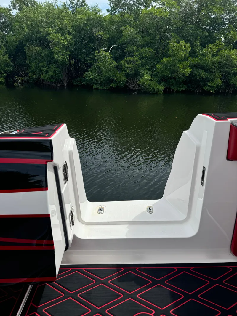 Slide: The Image of Deep Impact 399 boat, 2022 model, with open deck view by a lush riverbank. - 14