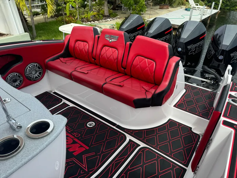 Slide: The Image of Red and black seating on 2022 Deep Impact 399 boat with powerful engines. - 15
