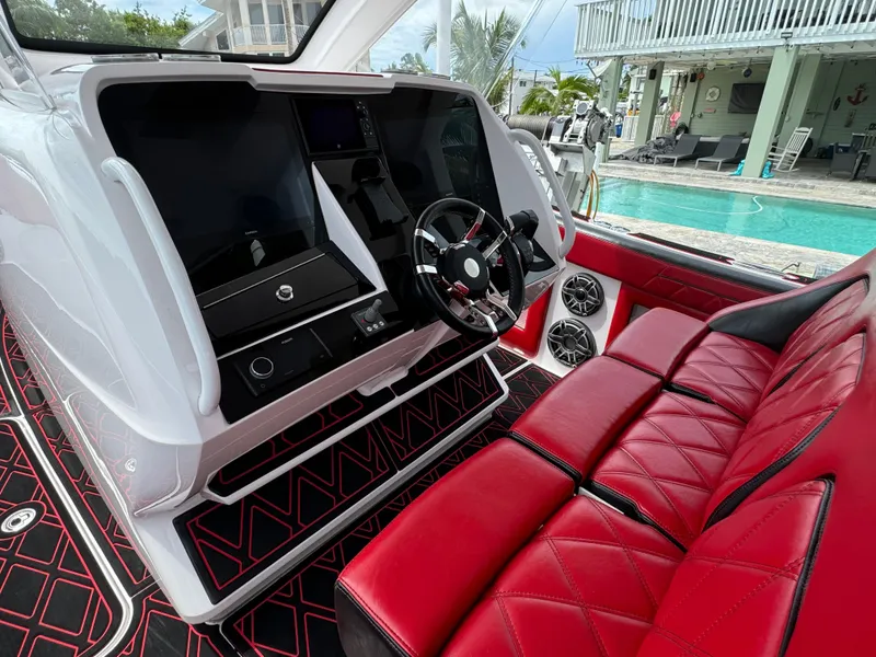 Slide: The Image of Luxury Deep Impact 399 boat interior with red seating and modern dashboard, 2022 model. - 19
