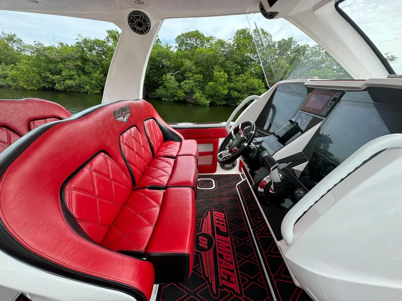 Slide: The Image of Luxurious 2022 Deep Impact 399 boat interior with red leather seats and advanced dashboard. - 21