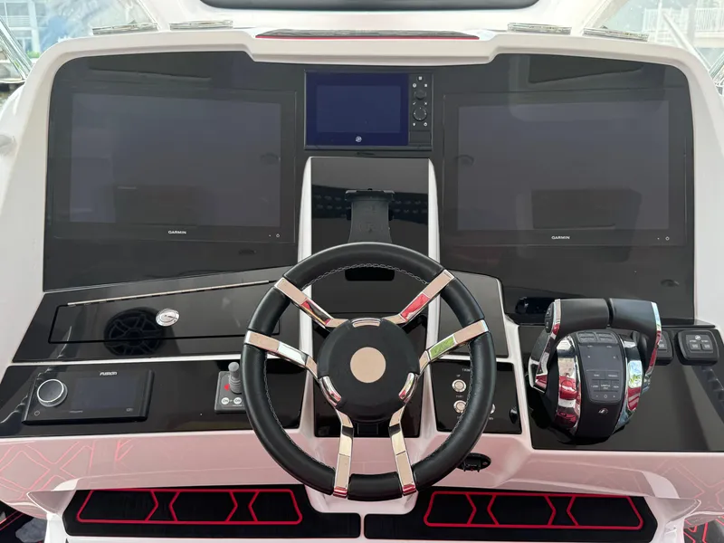 Slide: The Image of Steering console of 2022 Deep Impact 399 boat with dual screens and controls. - 25